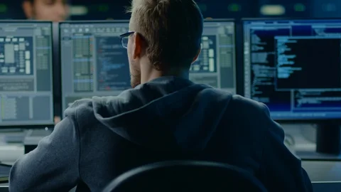 IT Specialist Working on Personal Computer with Screens Showing Software Program Stock Footage 103515373