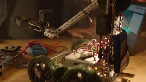 IT specialist is working on a robot with a keyboard Video stock 199222515