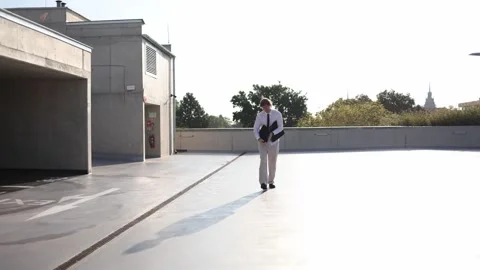 IT specialist works on a laptop while walking outdoors managing software project Stock Footage 346362115