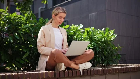 IT specialist writes a piece of code, enjoying the warmth of sunny day. Stock-Footage 247434554