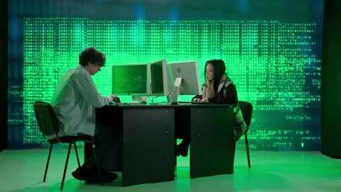 IT specialists against big digital screen. Man and woman programmers engineers Stock Footage 265572379