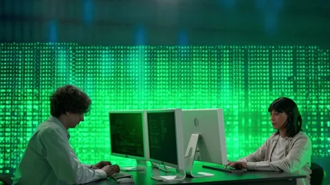 IT specialists against big digital screen. Man and woman programmers engineers Stock Footage 265573281