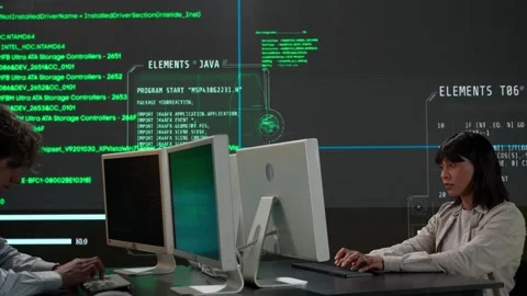 IT specialists against big digital screen. Man and woman programmers engineers Stock Footage 265573996
