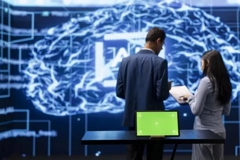 IT specialists in high tech location work on chroma key notebook Foto stock