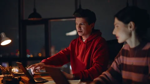 IT specialists programming night coworking space closeup. Two coworkers typing Stock Footage 309782564