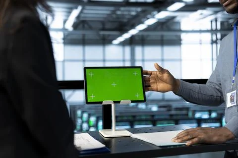 IT specialists talking, using mockup tablet, ensuring stable operations, closeup Foto stock
