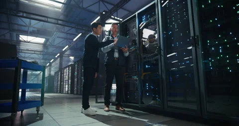 IT Specialists Working with Laptop Computer in Data Center Stock Footage 320000247