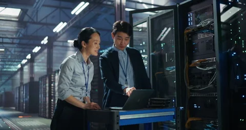 IT Specialists Working with Laptop Computer in Data Center Stock Footage 320000636