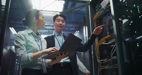IT Specialists Working with Laptop Computer in Data Center Stock Footage 320001866