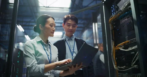 IT Specialists Working with Laptop Computer in Data Center Stock Footage 320001873