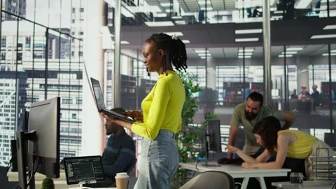 IT staff member using laptop to do programming in office Stock Footage 318162768