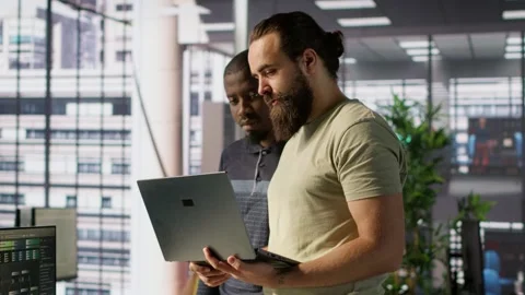 IT staff members in office analyzing and interpreting complex data Stock Footage 318159720