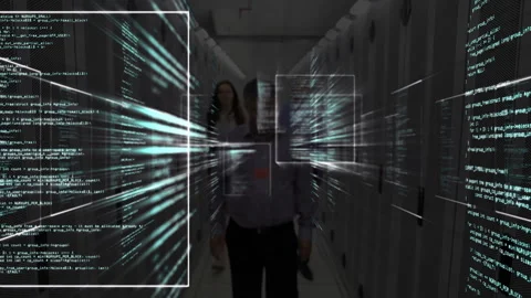 IT staff walking among server racks, holographic code panels materializing for Stock Footage 311884253