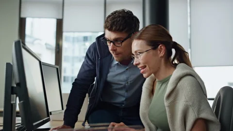 It supervisor helping colleague at workplace. Friendly man engineer consulting Stock Footage 242987369