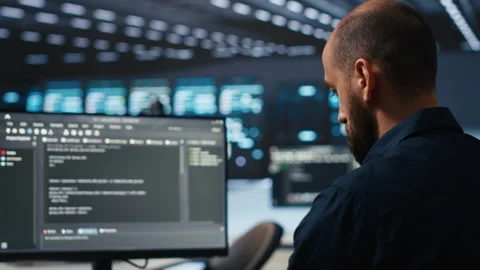 IT supervisor overseeing server room, running code on PC, troubleshooting rigs Stock Footage 274534538