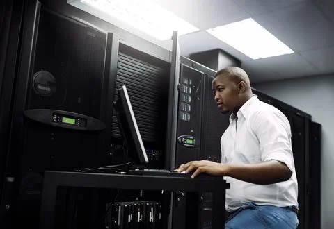IT support, black man or coding on laptop in server room for big data, network Stock Photos