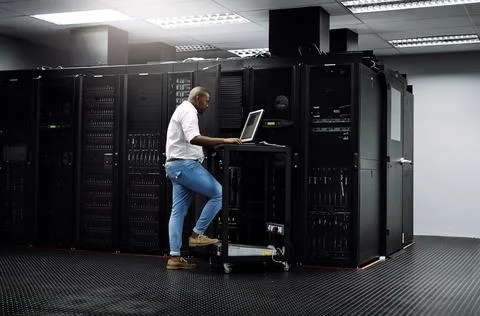 IT support, black man or coding on computer in server room for big data, network Stock Photos