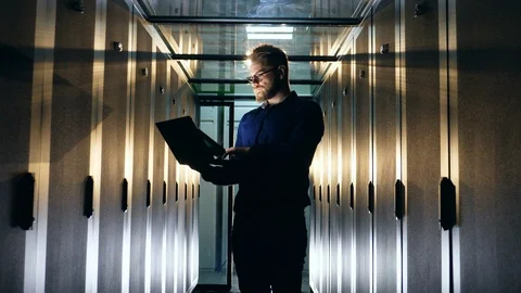 IT support engineer, programmer works with server room machines. Stock Footage 118615517