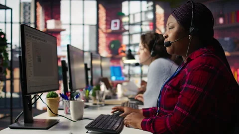 IT support expert in call center troubleshoots errors to minimize downtime Stock Footage 305398001