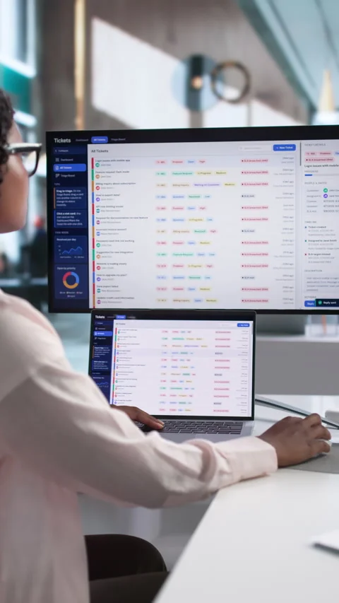 IT Support Specialist Carefully Manages Helpdesk Tickets Using Laptop Stock Footage 339192785
