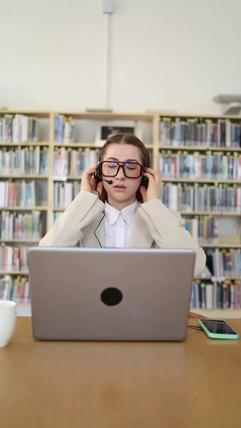 IT support specialist puts on headset before starting an online customer call Vidéo 342179015
