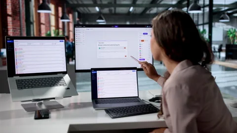 IT Support Specialist Resolves Incident Tickets Using Laptop Stock Footage 335459366