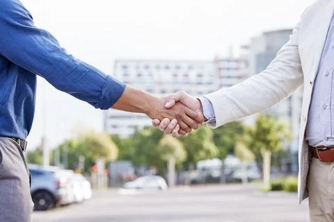 It takes two flints to make a fire. two unrecognizable businesspeople shaking Stock Photos