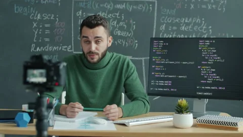 IT teacher recording lesson with digital camera explaining software coding in Stock Footage 205845741