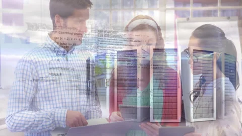 IT team collaborating around laptops, displaying code overlay and flipchart Stock Footage 307443797