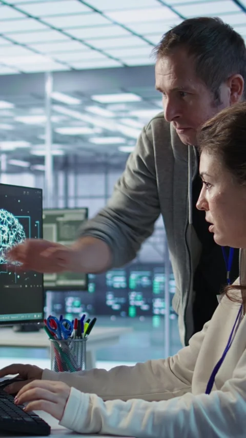 IT team members programming scripts on computer, employing AI machine learning Stock Footage 319576015