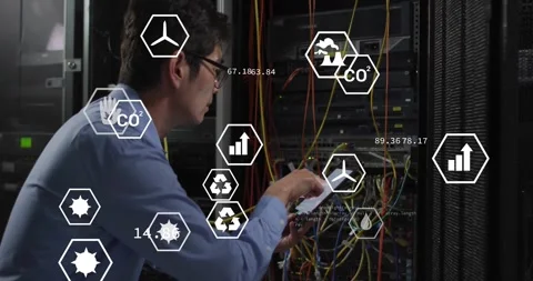 IT tech plugging cables and swiping tablet adding floating eco metrics icons Stock Footage 330725454