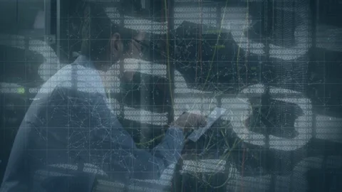 IT tech tapping tablet, tracing cables at data center, animated maps overlaying Stock Footage 332577594