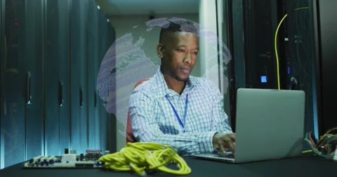 IT tech typing on laptop near LAN cables, monitoring network with rotating globe Stock Footage 331757161