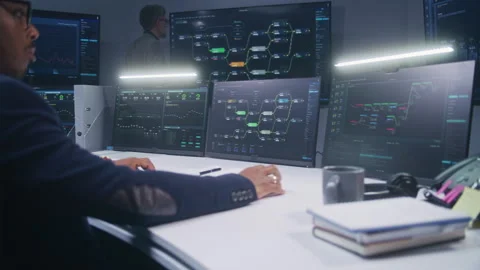IT technical specialists sit in front of computers with data server Stock Footage 244412718
