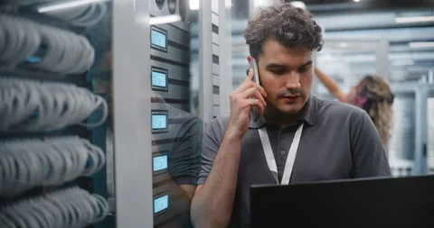 IT Technician Checking Server Diagnostics While Reporting Technical Readings Stock Footage 344957076