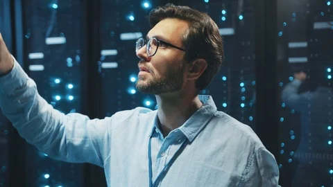 IT technician in data center digital server room controlling work of rack server Stock Footage 119278949