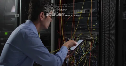 IT technician kneeling at server rack tapping tablet initiating code overlays Stock Footage 313704417