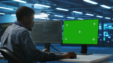 IT technician overseeing supercomputers using chroma key PC monitor Stock Footage 276141314