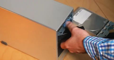 IT Technician Removes Hard Drives from External RAID Array Stock Footage 64497687