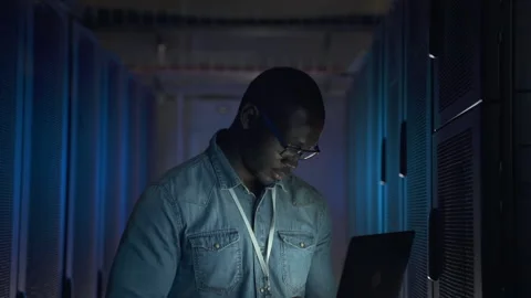 IT technician sets system black man with notebook by server Stock Footage 163814032