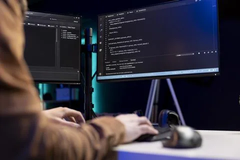 IT technician typing on keyboard, installing safeguard code on PC Stock Photos