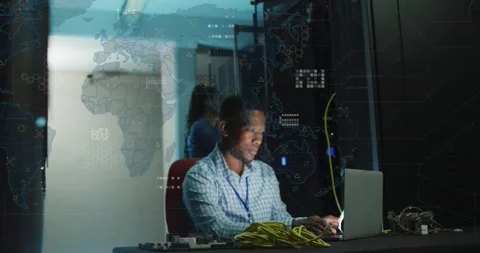 IT technician typing laptop in server room, initiating animated network map Stock Footage 331757156