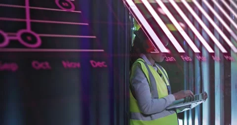 IT technician typing on portable computer in server aisle, checking racks while Stock Footage 331756977