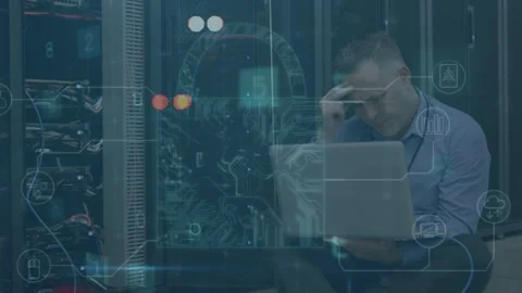 IT technician using laptop beside server racks starting scan, overlays flagging Stock Footage 335282677