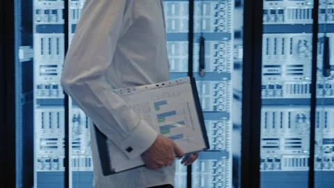 It technician walking in a server room data center Stock Footage 348696604