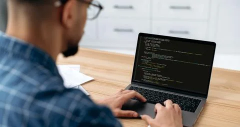 IT technology. Panoramic photo of a programmer with laptop. View over the Stock Photos