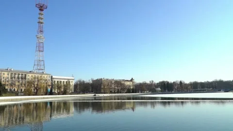 It was a bright and clear day at the picturesque lakeside park, where the tall r Stock Footage 344518678