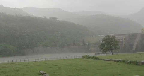 It was raining heavily over the ruins of a camp, in the distance you can see Stock Footage 166316456