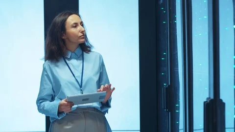 IT woman engineer doing cloud-based diagnostics with digital tablet visually Stock Footage 125758316