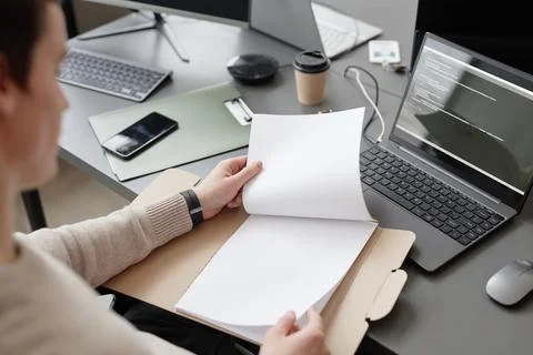 IT Worker Looking Through Papers in Office Stock Photos